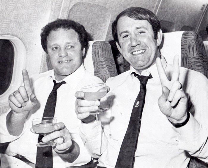 Mick Heaton and Howard Kendall toast victory on the plane home from Rotterdam