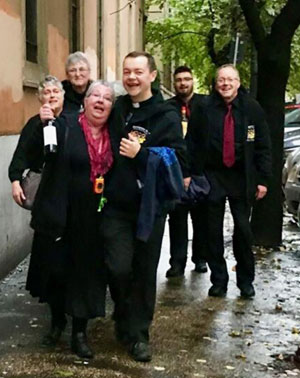 Our partying priest and our tour coordinator, both slightly sauced, caper down a sidewalk in Italy. I’m at far right, cracking up