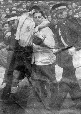 Leyfield helping Nat Lofthouse off the pitch after he was injured scoring against ireland on 11 November, 1953