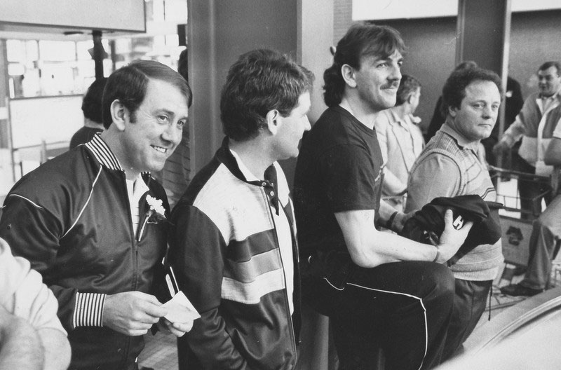 Heaton, Kendall, Harvey and Southall await their luggage at the airport carousel